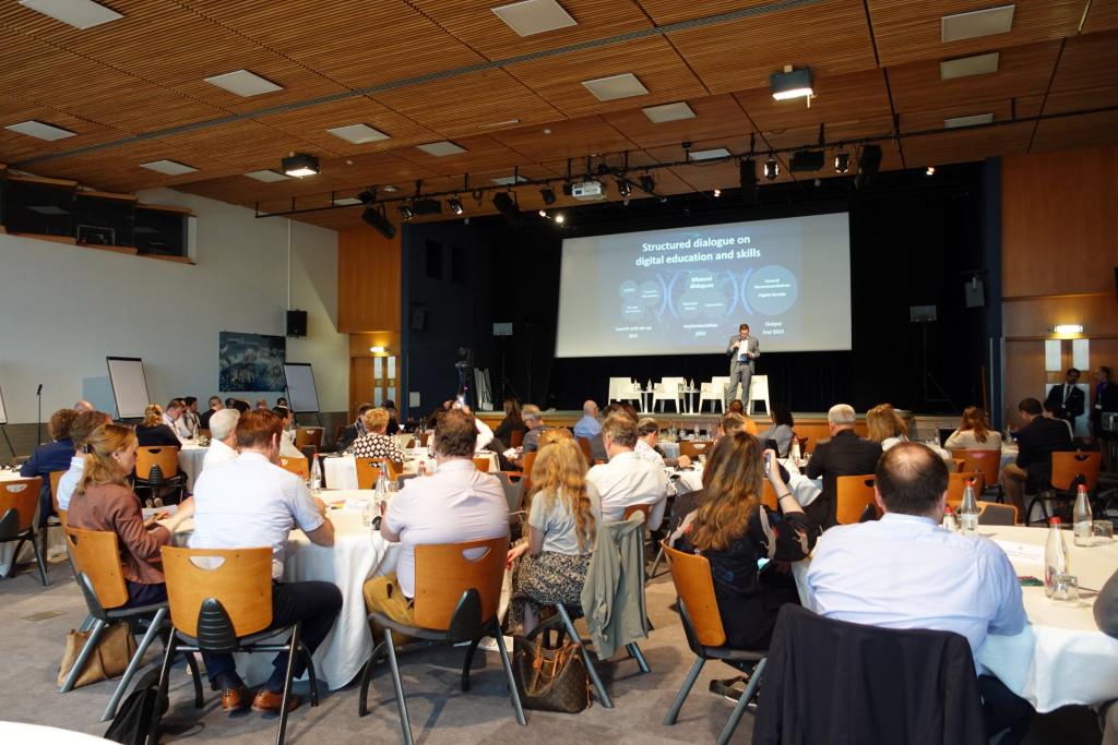 image of participants listening to presenter on stage