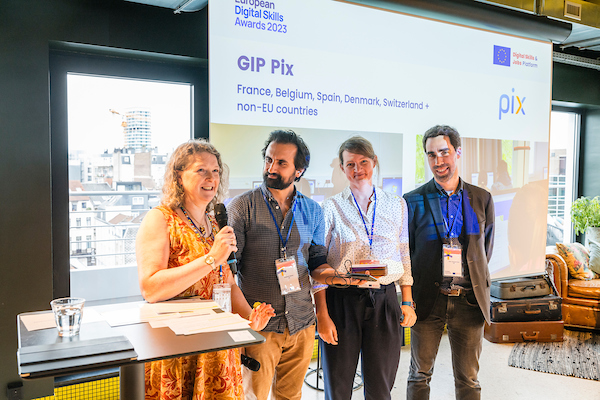 three members of the Pix team receive the award from June Kingston