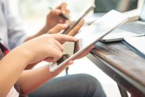 Freepik designed image - photo of a person's hands working on a tablet 