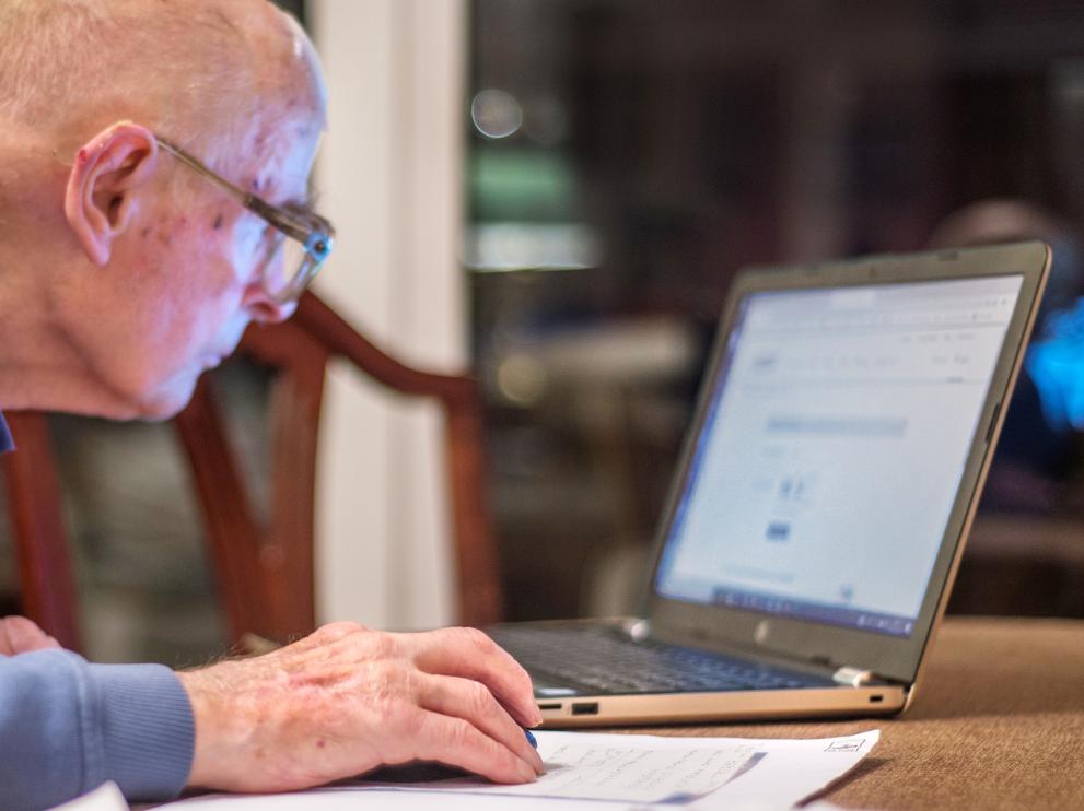 An old man in front of a computer An old man in front of a computer