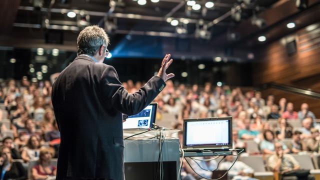 Speaker giving a talk on corporate business conference