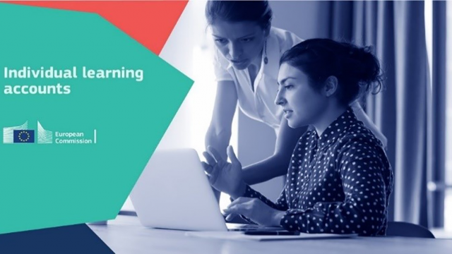 Two people watching at a laptop.