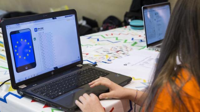 a girl with long dark hair working at her computer