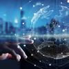Decorative image of digital transformation, hand approaching a model of the Earth digitally showed