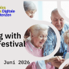 A group of older adults looks at a smartphone together. Announcement for the Aging with Tech Festival