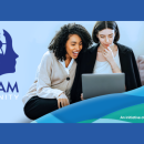 Three young women looking at a computer screen and talking among themselves