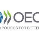 Logo of the OECD. Planet Earth is on the left with two arrow heads next to it pointing right with OECD written next to it. Text below states "better policies for better lives"