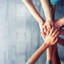 Hands stretched together, as a sign of cooperation