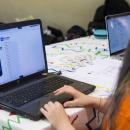 A young girl coding on a laptop computer