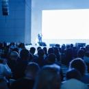 Business and Entrepreneurship concept. Speaker giving a talk in conference hall at business event. Audience at the conference hall